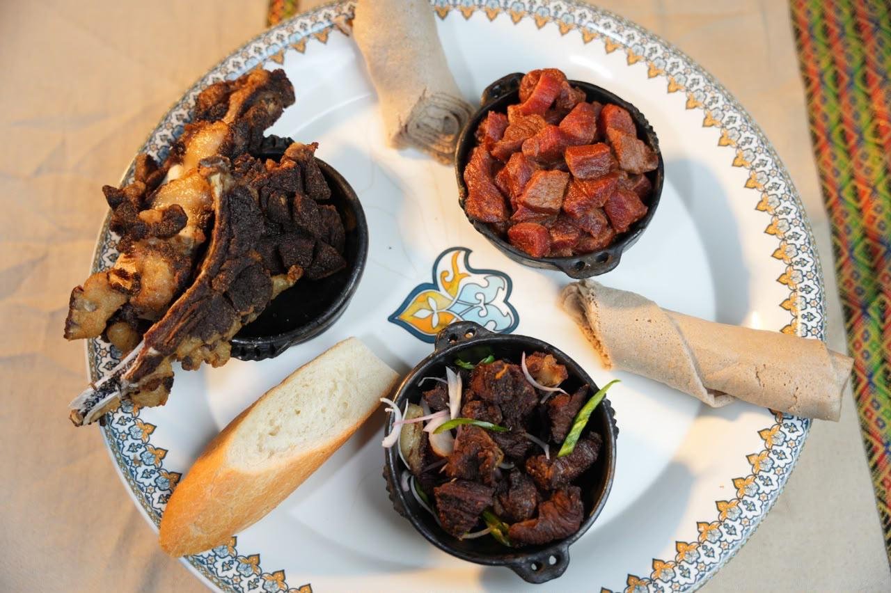 Ethiopian meat platter with injera and sauces