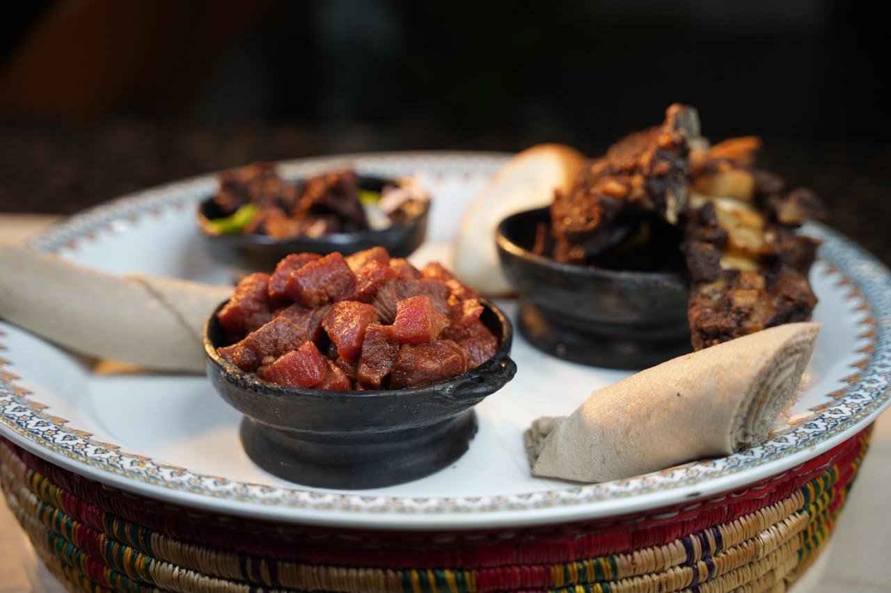 Fresh cuts of meat with injera