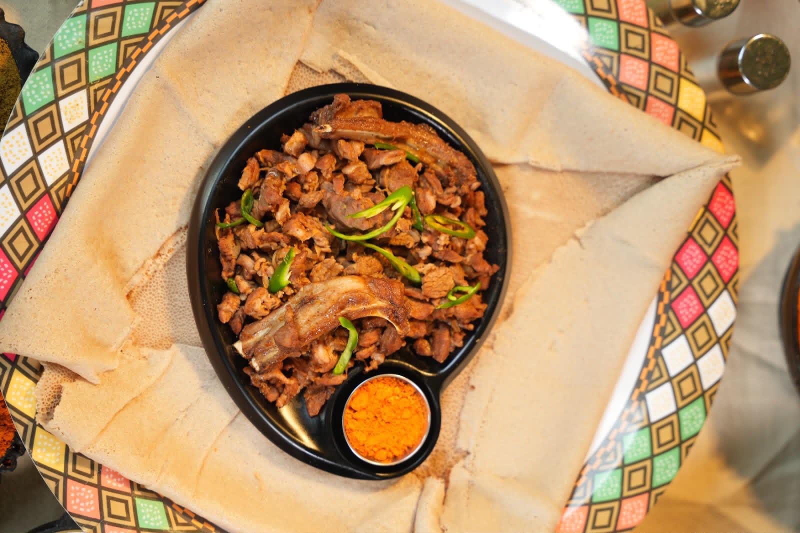 Ethiopian meat dish with peppers and injera